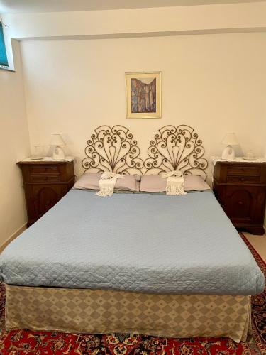 a bedroom with a large bed with two night stands at A casa di Asia in Viterbo