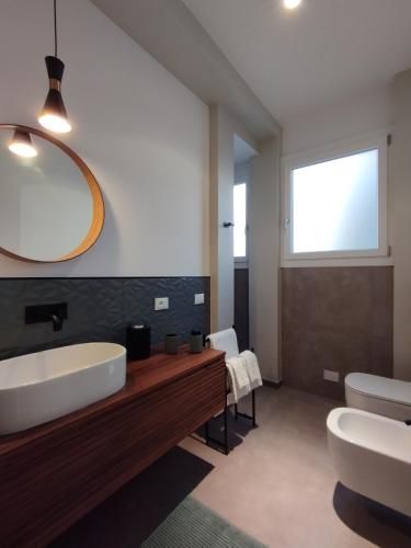 a bathroom with a tub and a sink and a mirror at A casa di Twiggy in Bologna