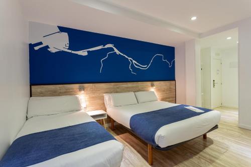Ένα ή περισσότερα κρεβάτια σε δωμάτιο στο Casual Blue