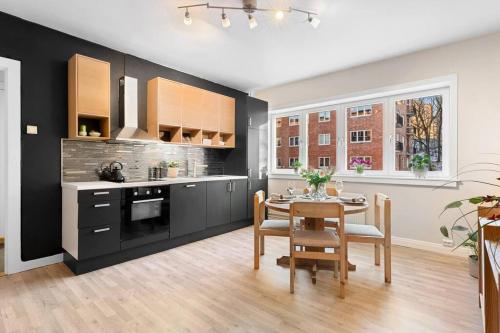 a kitchen with a table and a dining room at Demims Apartments Oslo -- Cozy, Central & Stylish in Oslo