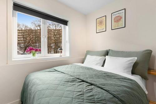 a bedroom with a bed and a window at Demims Apartments Oslo -- Cozy, Central & Stylish in Oslo