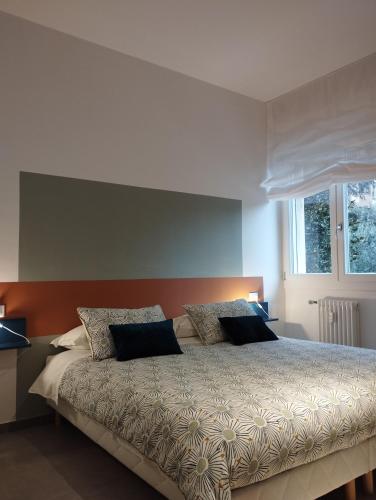 a bedroom with a bed with two pillows on it at A casa di Twiggy in Bologna