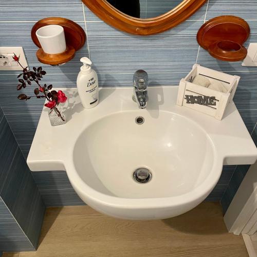 a white sink in a bathroom with a mirror at A casa di Asia in Viterbo