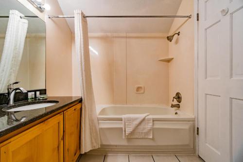 a bathroom with a tub and a sink at Multi Resorts at Lift Lodge in Park City