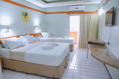 Tempat tidur dalam kamar di Hotel Praia Ponta d'Areia