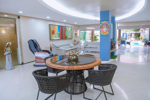 a lobby with a table and chairs in a mall at Hotel Praia Ponta d'Areia in São Luís
