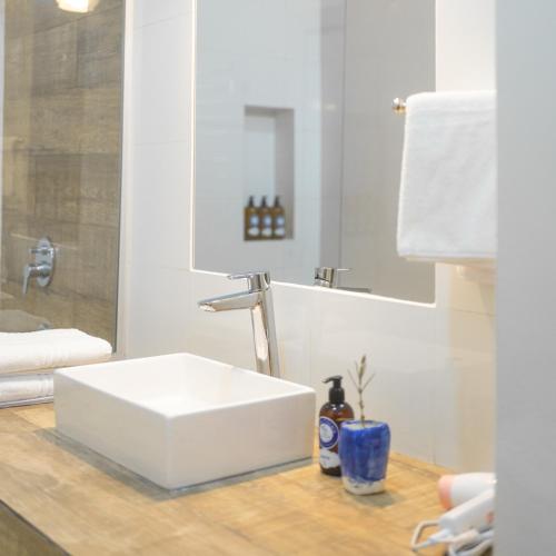 a bathroom with a white sink and a mirror at Bella Tilcara Boutique Hotel in Tilcara