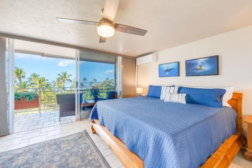 a bedroom with a blue bed and a balcony at Island Surf 601 in Kihei