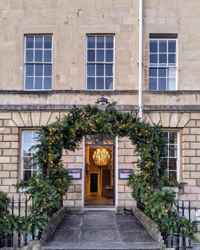 an entrance to a building with christmas decorations at No 15 by GuestHouse, Bath in Bath