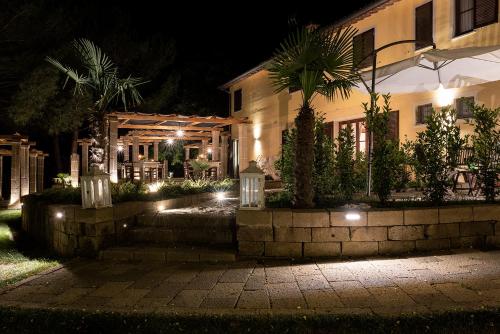 a house at night with lights in front of it at Antiqua Vallis in Palaia