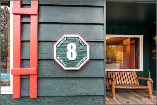 a sign on the side of a building with a bench at Brundage Bungalows in McCall