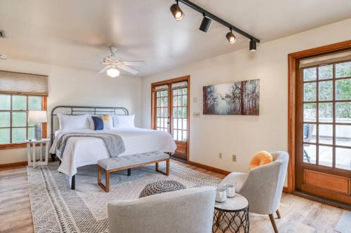 a bedroom with a bed and a couch and chairs at 62 Hypolita Carriage House in Saint Augustine