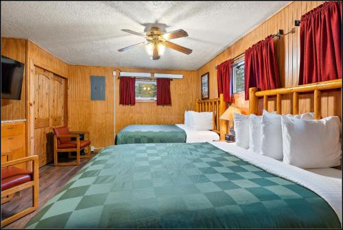a bedroom with two beds and a ceiling fan at Brundage Bungalows in McCall