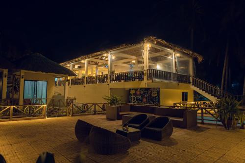 a large building with a balcony and a patio at night at Paradise Resort Doc Let - All Inclusive in Doc Let