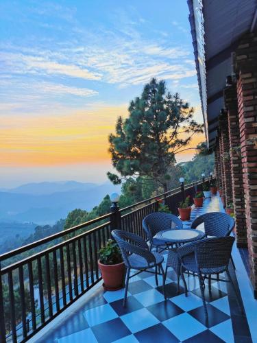 a balcony with chairs and tables and a view at The Lanswood Estate in Lansdowne