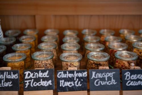 a group of jars filled with food on a shelf at Hotel Pollux in Zermatt