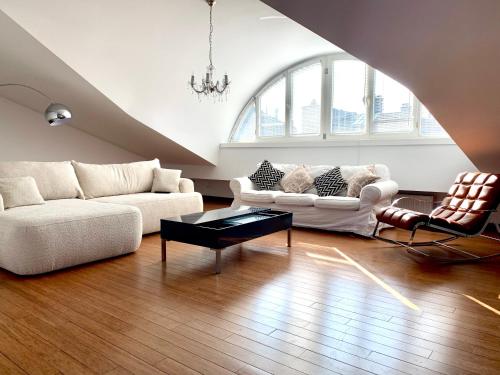 a living room with two couches and a coffee table at Divon Luxury Apartments by Wawel Castle in Kraków