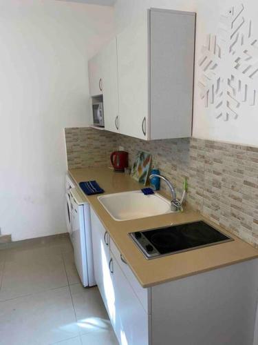 a kitchen with a sink and a counter top at Haifa boutique apartment by LIME in Haifa