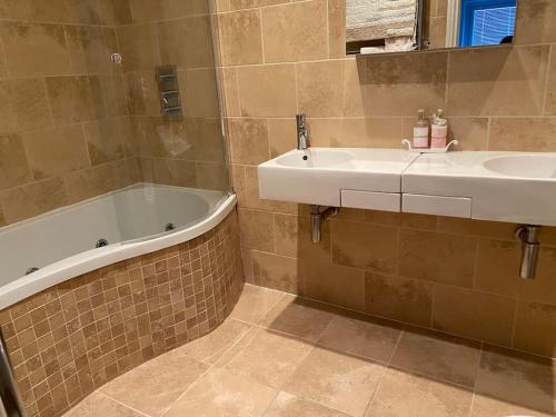 a bathroom with a bath tub and a sink at Marina View in Newcastle upon Tyne