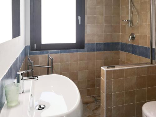a bathroom with a white sink and a shower at CASE BELVEDERE in Chia