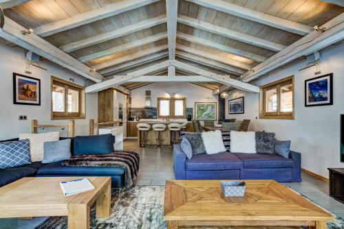 un salon avec des canapés bleus et une table dans l'établissement Chalet Panache, à Chamonix-Mont-Blanc