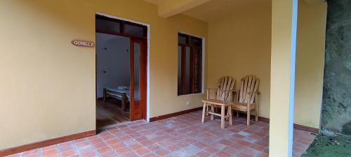 an empty room with two chairs and a table at Nshongi Camp in Rubuguli