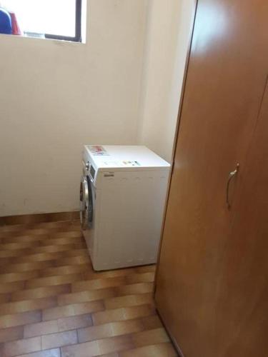a laundry room with a washer and dryer next to a door at Mini appartamento panoramico in Sùtrio