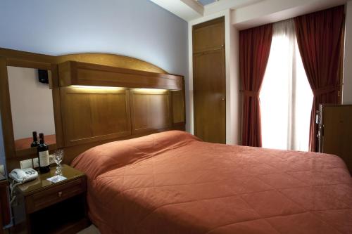 a hotel room with a bed and a window at Hotel Katerina in Athens