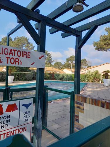 a swimming pool with a sign that reads qualify chlorine gym for swimming at Talaris La Palmyre in Les Mathes