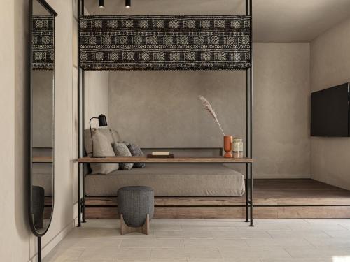 a bedroom with a bed with a desk and a tv at Lindian Village All Inclusive Resort Rhodes,Curio Collection in Kiotari