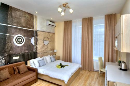 a hotel room with a bed and a couch at Fire Inn in Kyiv