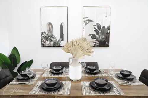 a dining room table with a vase on it at BoHo Modern Retreat King Bed,Fireplace,Disney in Edmonton
