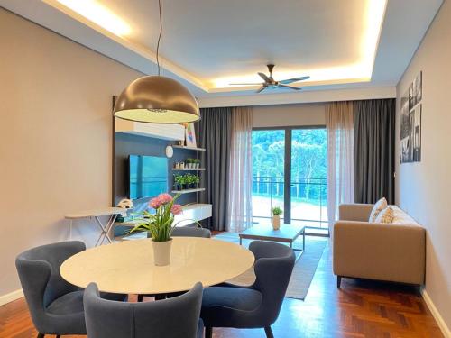 a living room with a table and chairs at Genting Highlands Vista Residences Free Wi-Fi & 1 Parking in Genting Highlands