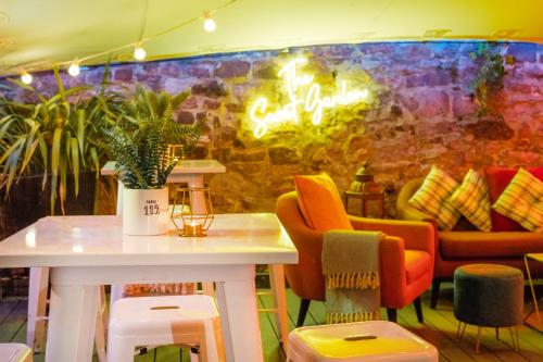 a room with a table and chairs and a wall at The Berkeley Square Hotel Bristol in Bristol
