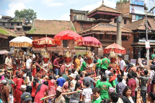 a group of people in a crowd in a parade at Peacock Guest House in Bhaktapur