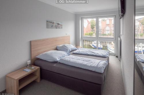 a bedroom with two beds and a window at Marina 22C in Cuxhaven