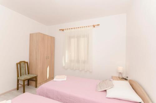 Postel nebo postele na pokoji v ubytování Apartments Silvana
