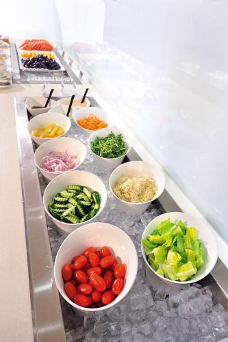 a group of bowls of vegetables on a counter at Fuward Hotel Tainan in Tainan