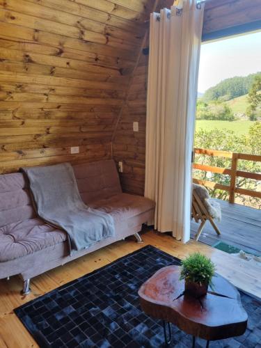 a living room with a couch and a table at Cabanas Bela Vista in Rolante