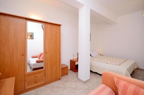 a bedroom with a bed and a mirror at Apartments Bovarovic in Pula