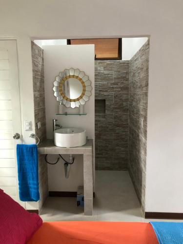 a bathroom with a sink and a mirror at Villa Wolaba in Puerto Viejo