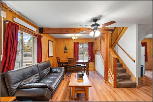 a living room with a leather couch and a table at Brundage Bungalows in McCall