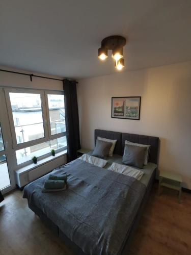 Postel nebo postele na pokoji v ubytování Apartamenty Piaskowe