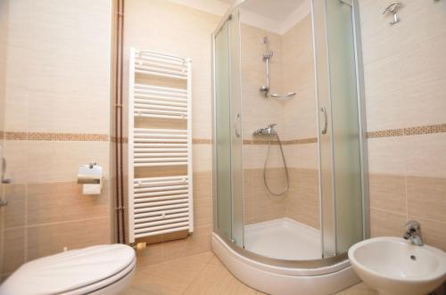 a bathroom with a shower and a toilet and a sink at Apartments Marija in Cres