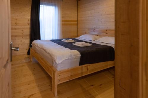a bedroom with a bed with two towels on it at Ranch in Variani in Variani