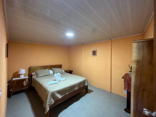 a bedroom with a bed with a towel on it at Lidia's Mountain View Vacation Homes in Monteverde Costa Rica