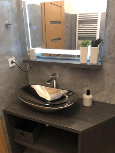 a bathroom with a sink and a mirror at Luma Exclusive in Osijek