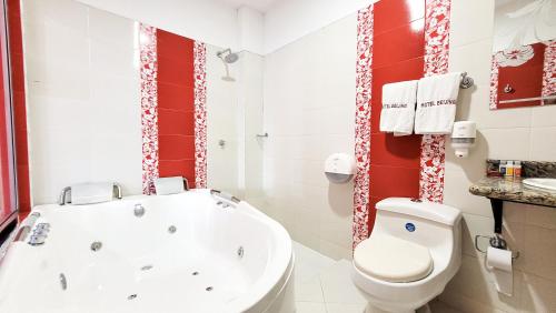 a bathroom with a tub and a toilet and a sink at Hotel Beijing Caucasia in Caucasia
