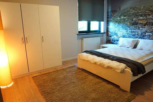 ein Schlafzimmer mit einem großen Bett und einem Schrank in der Unterkunft Apartamenty Milenium in Ustroń