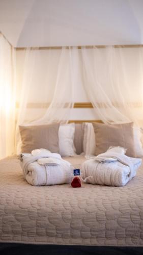 a bedroom with a bed with white towels on it at Hotel de Maître de Vaughan in Brussels